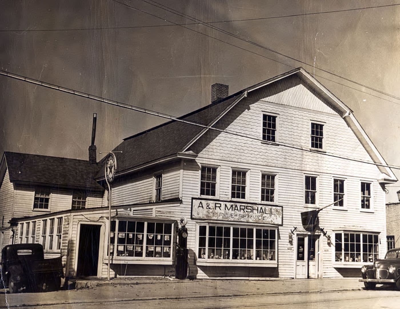 The wood-frame A and R Marshall Marine Service storefront at 403 Main Street